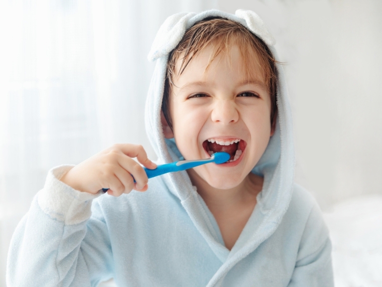 A happy child brushing their teeth