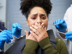 A woman experiencing dental anxiety or dental phobia