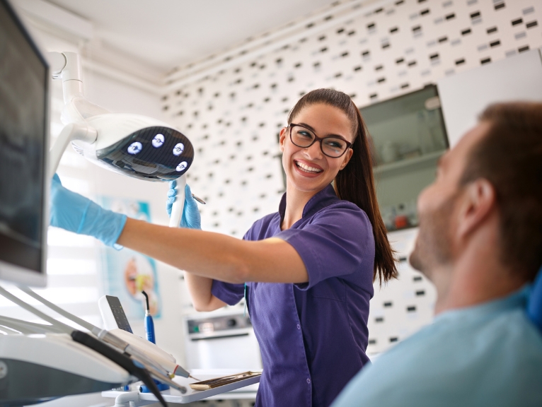 Dentist supporting a patient in a modern dental practice while preparing for GDC 2026 standards.