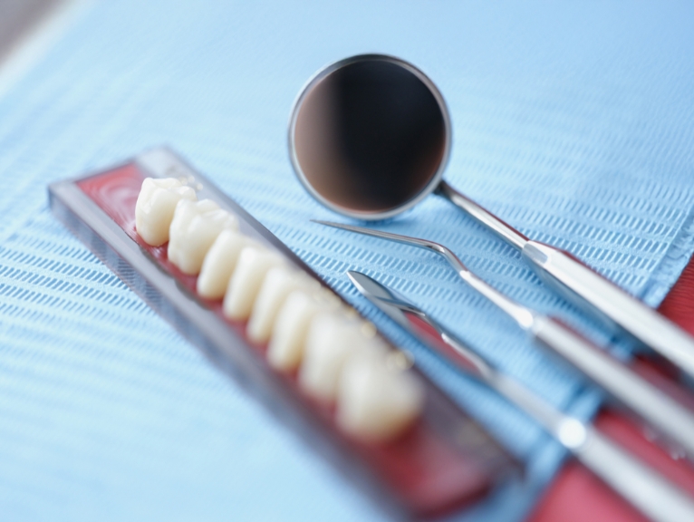 Dental Equipment Hampshire: Dental instruments and shade guide displayed on a blue clinical tray.